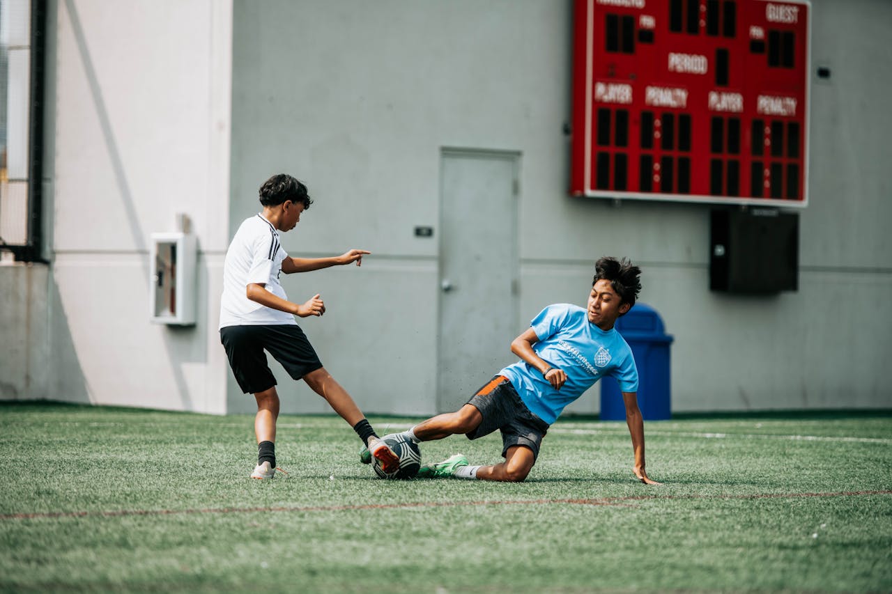 Young soccer players engage intensely on a sunny day in Milwaukee, showcasing action and sportsmanship.